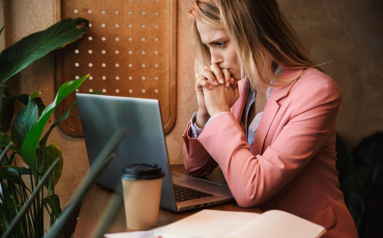 Attractive worried young businesswoman