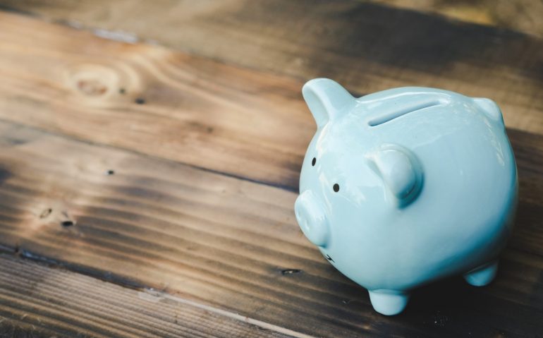 Blue piggy bank on old wooden floor. ideas about saving money for future use - business success concept.