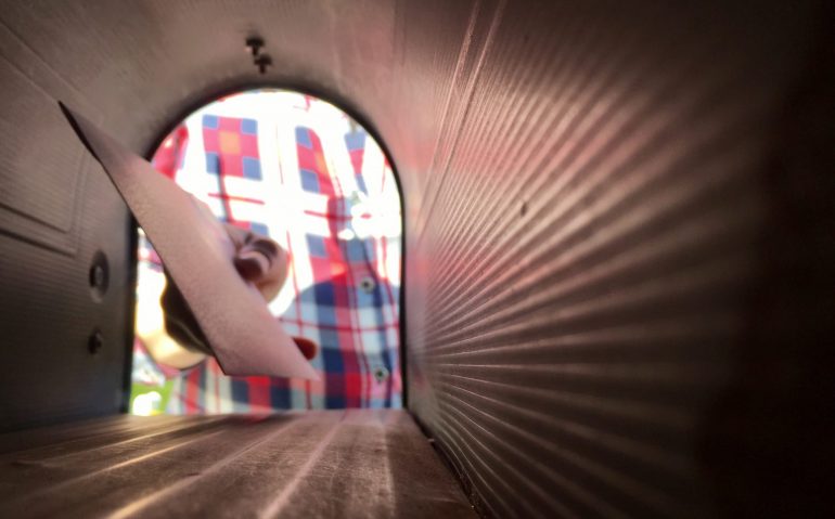 looking-through-a-mailbox-to-see-womans-hand-takin-W398SDB